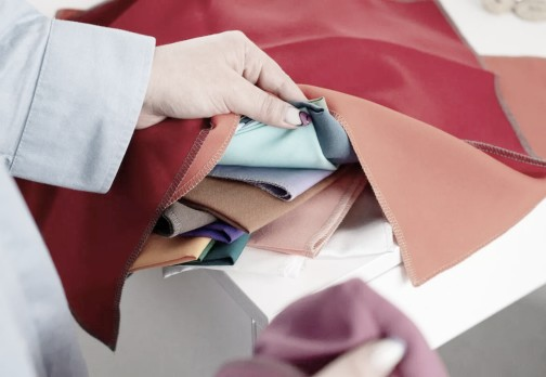 Person handling colorful fabric pieces