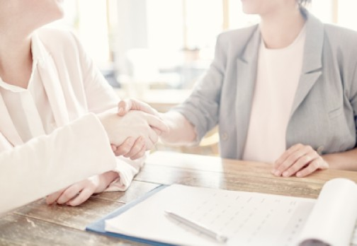 Two businesswomen shaking hands