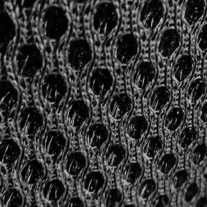 Breathable black mesh fabric for custom gloves.