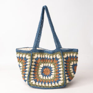 Blue woven tote bag with granny-square panels, side/top view