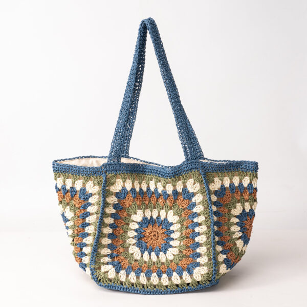 Blue woven tote bag with granny-square panels, side/top view