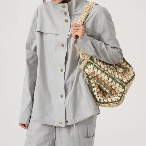 Model with natural beige crochet straw tote bag on shoulder