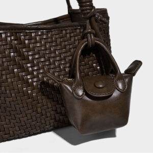 Detail of woven PU texture and matching mini pouch accent