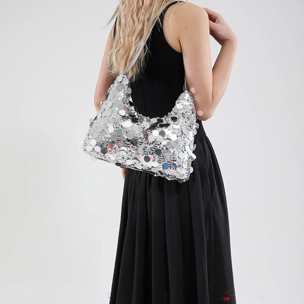 Model with silver underarm bag, back/shoulder view