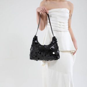 Model holding black sequin party purse, front view