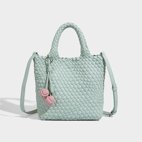 Mint green woven bucket tote with crossbody strap, front view