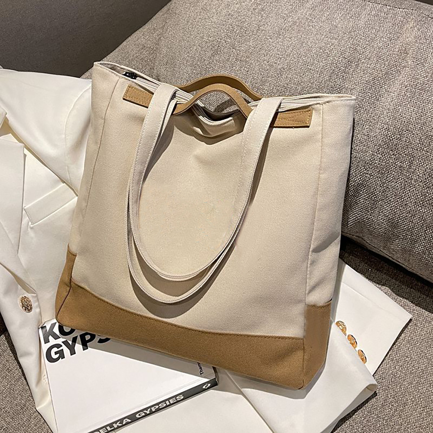 Cream canvas tote bag with large capacity, lifestyle on sofa