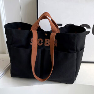 Black canvas tote handbag with organizer pockets and brown handles, bulk custom logo ready.