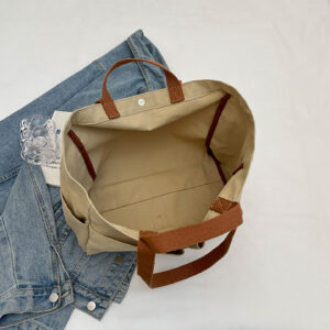 Interior view of large canvas tote with snap closure and flat bottom for easy packing.