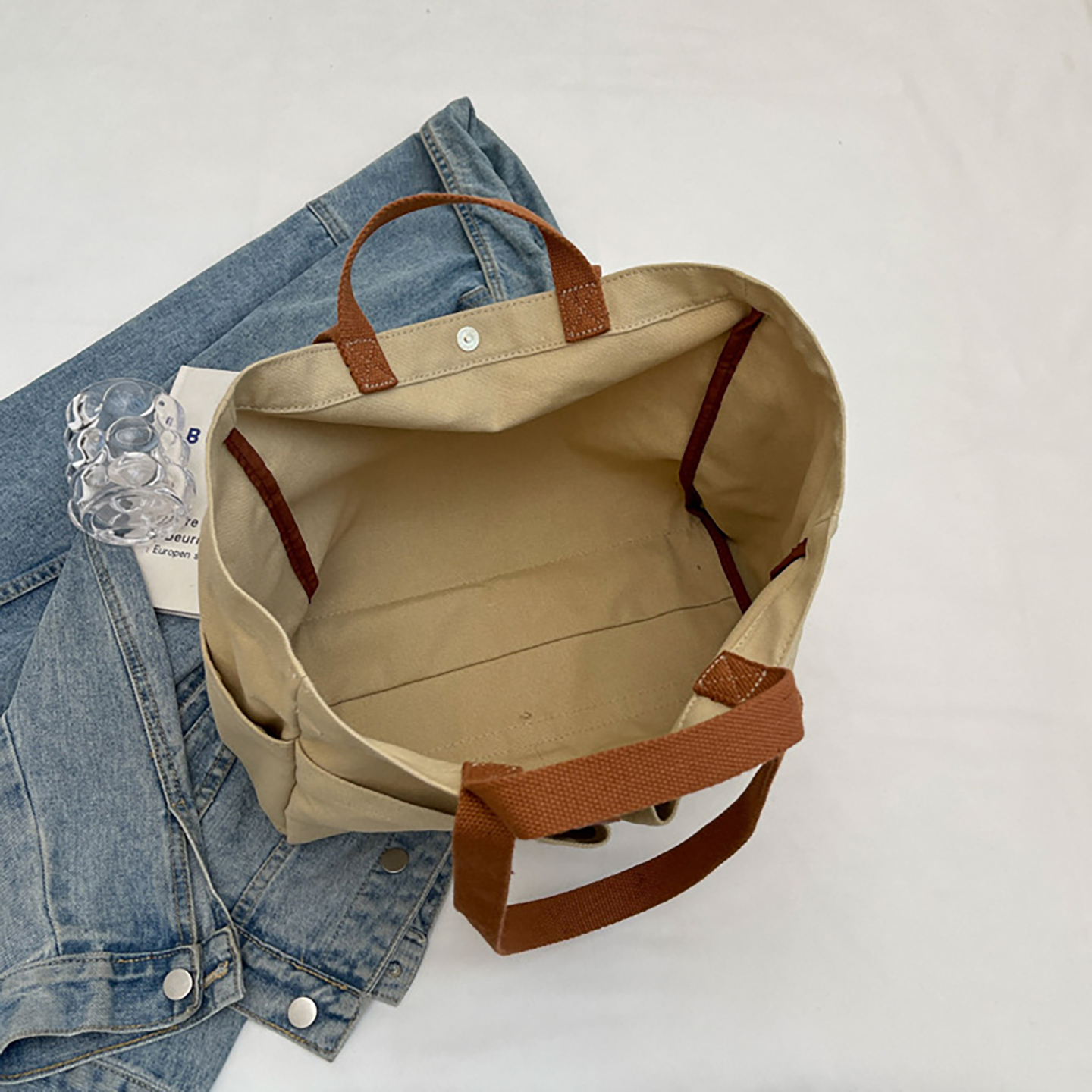 Interior view of large canvas tote with snap closure and flat bottom for easy packing.