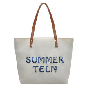 Off-white canvas tote bag with long brown straps and embroidered slogan, custom logo ready.