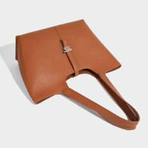 Side view of premium PU leather bell tote bag highlighting crossbody option.