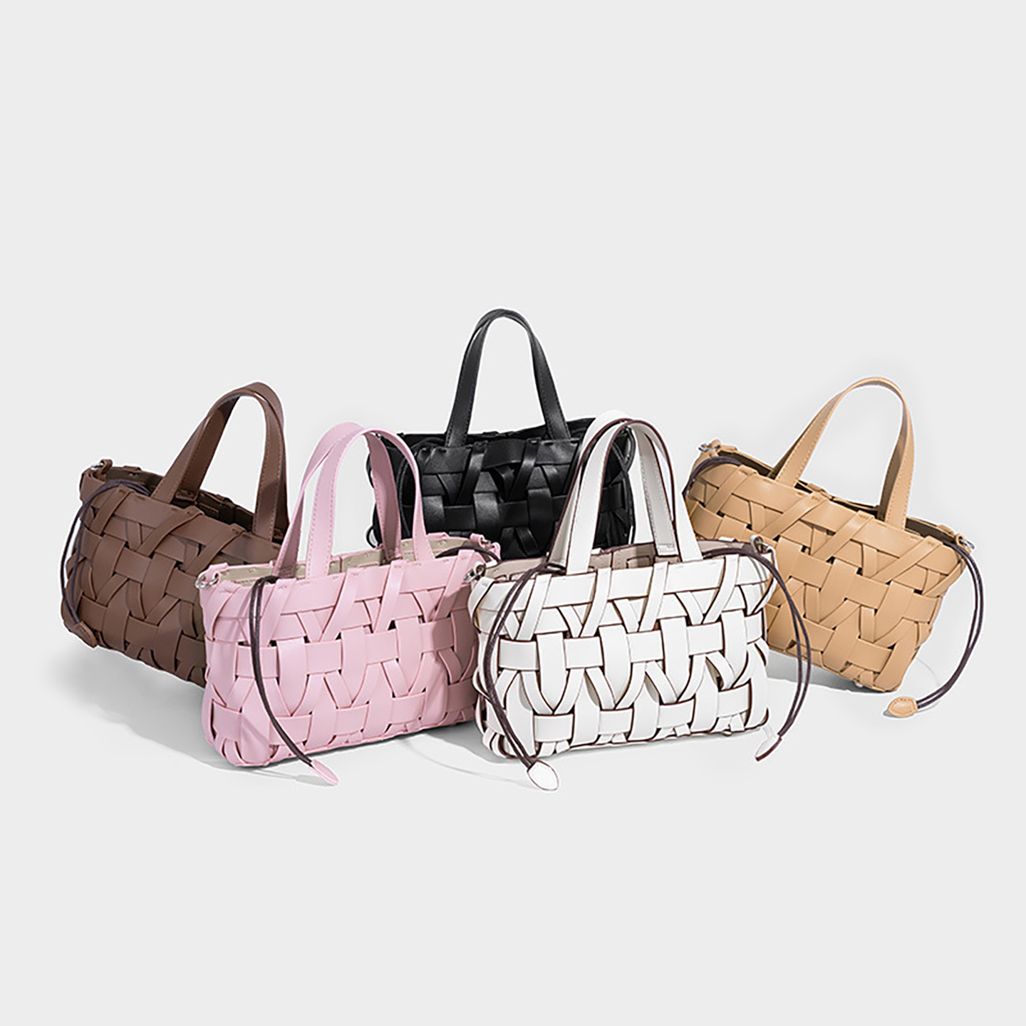 Group of premium PU woven bucket bags in various colors for wholesale