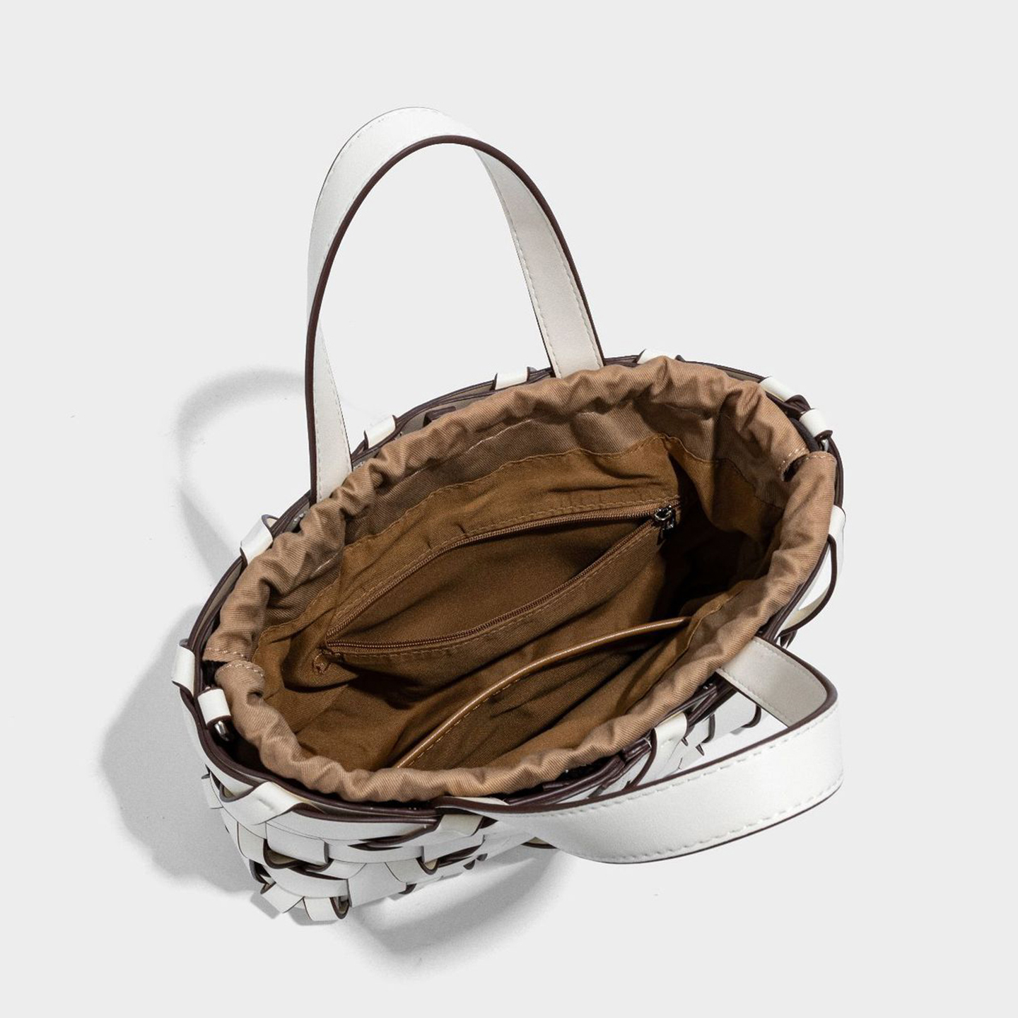 Interior view of premium PU woven bucket bag showing open pocket and microfiber lining