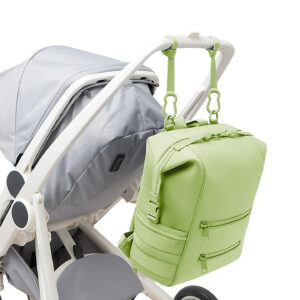 Green premium neoprene diaper bag backpack hooked on stroller for baby outings.