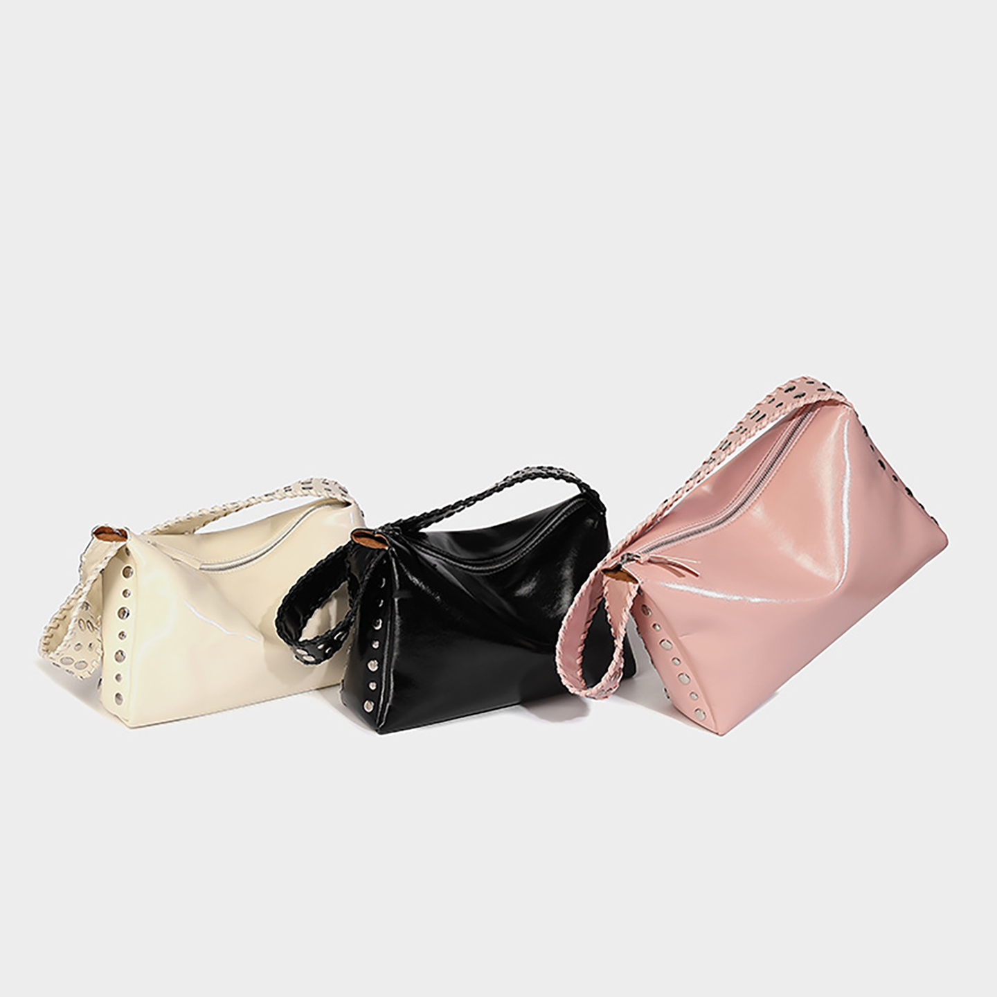 Group shot of oil wax PU leather shoulder bags in black, pink, and off-white colors