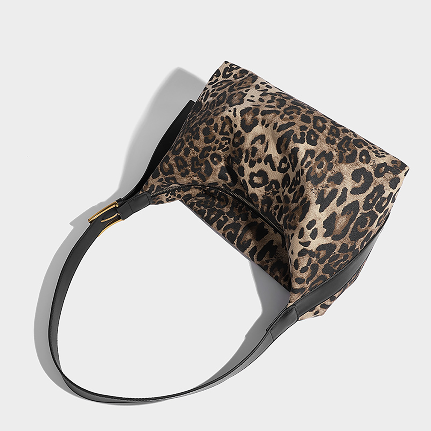 Close-up of leopard print shoulder bag fabric and hardware details