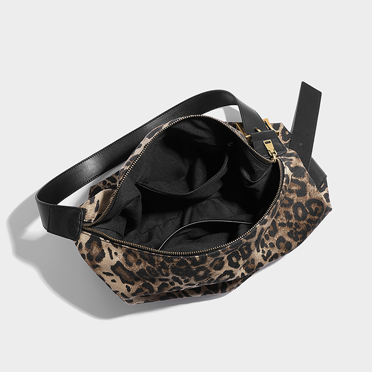 Interior view of leopard print bag displaying black lining and inner pockets
