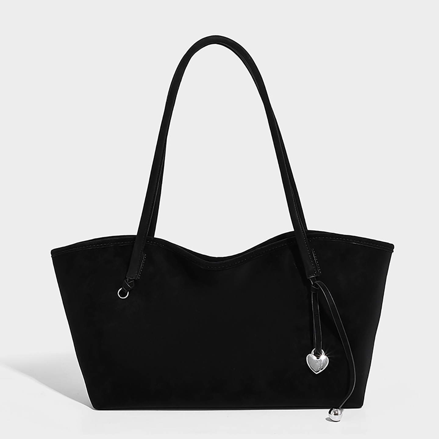 Front view of black slouchy suede tote bag for versatile styling