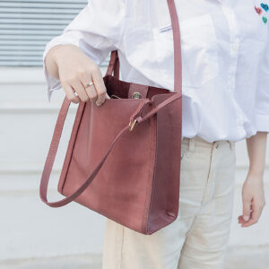 Lifestyle shot of burgundy leather hobo bag worn over shoulder