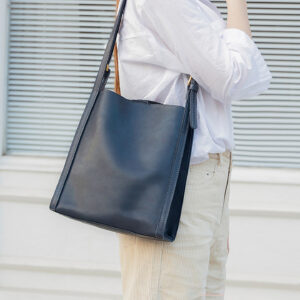 Lifestyle shot of navy leather hobo bag in casual setting