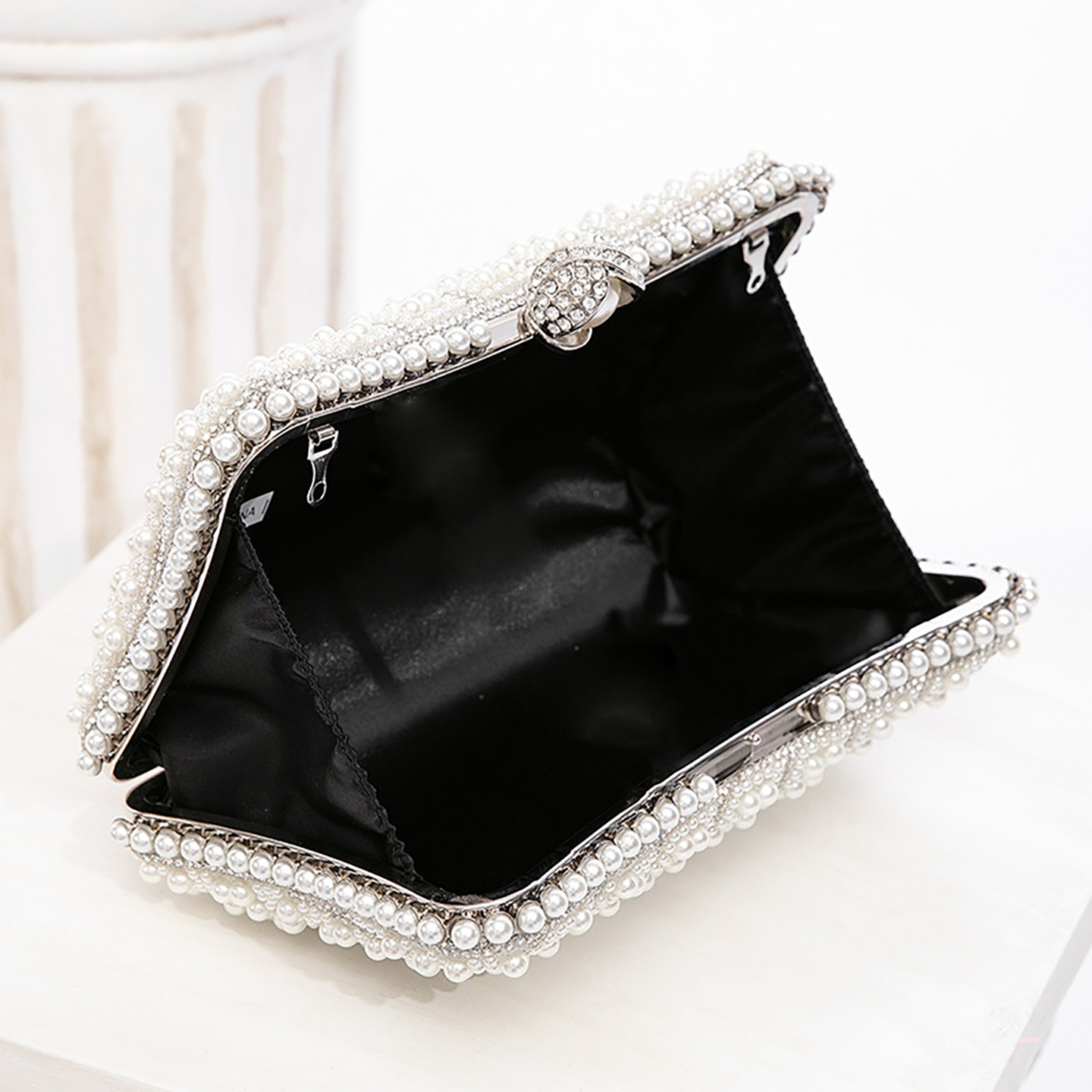 Open interior of women's clutch bag showing polyester lining and pockets