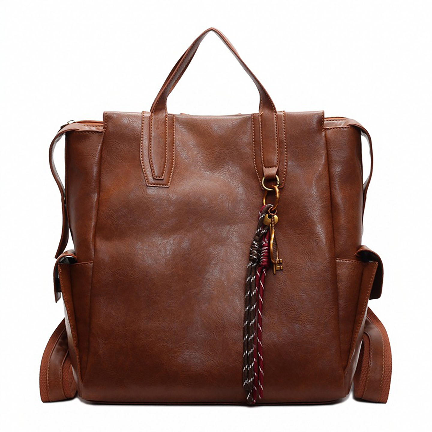 Front view of wholesale leather backpack in brown PU with tassel charm