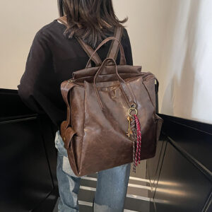 Woman wearing brown leather backpack on back for daily use
