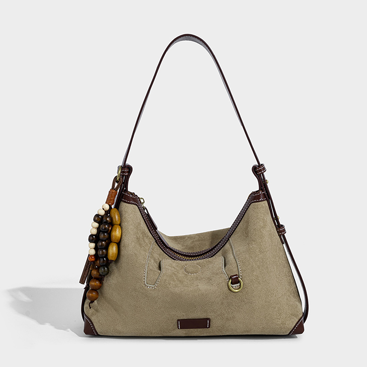 Front view of women's suede shoulder bag in khaki with ethnic charm