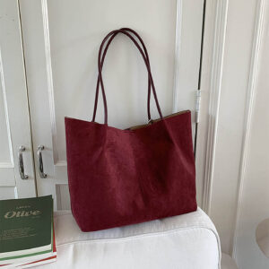Burgundy faux suede tote bag on table showcasing minimalist design