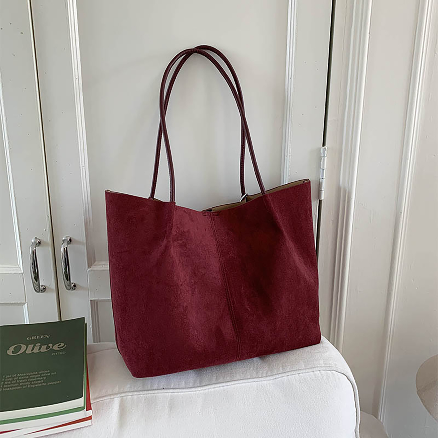 Burgundy faux suede tote bag on table showcasing minimalist design