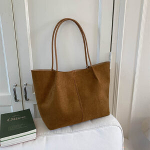 Side view of brown women's tote bag on shoulder during casual outing