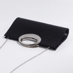 Black sequin evening bag styled as crossbody with chain strap, perfect versatile carry for cocktail parties and nightlife.