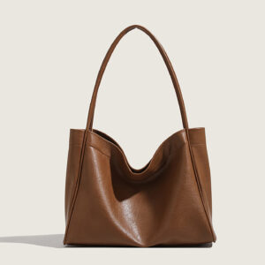 Side profile of brown large capacity crossbody bag for women, showing magnetic clasp
