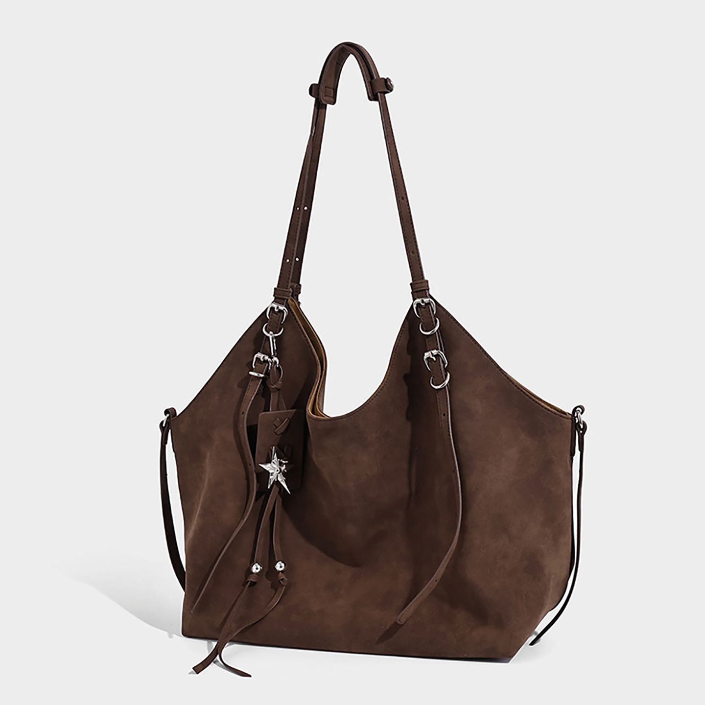 Side profile of dark brown retro shoulder bag, highlighting adjustable straps and slouchy shape