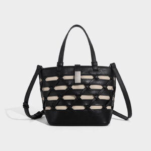 Straight-on view of black crossbody bucket bag showing bucket shape and zipper top.