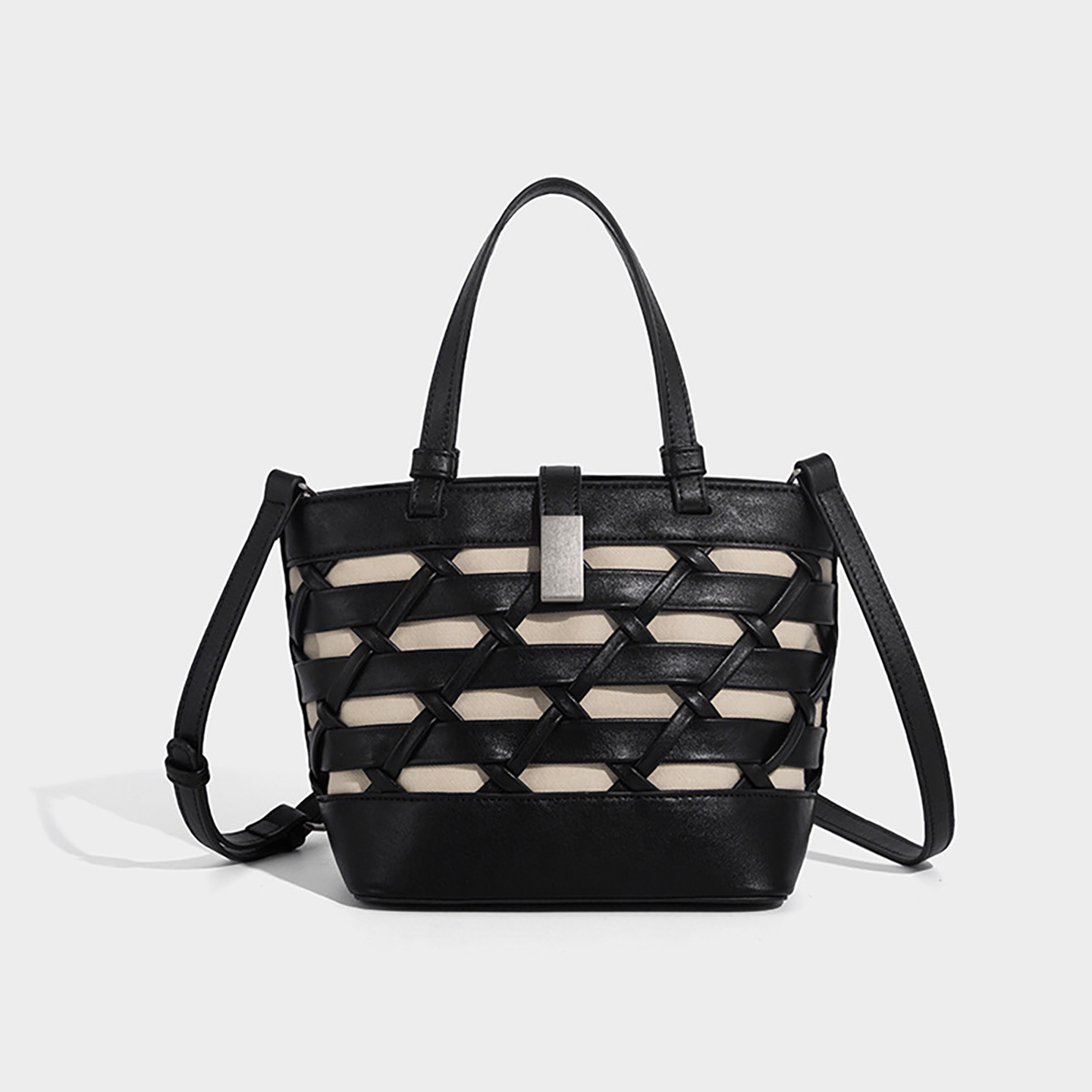 Straight-on view of black crossbody bucket bag showing bucket shape and zipper top.