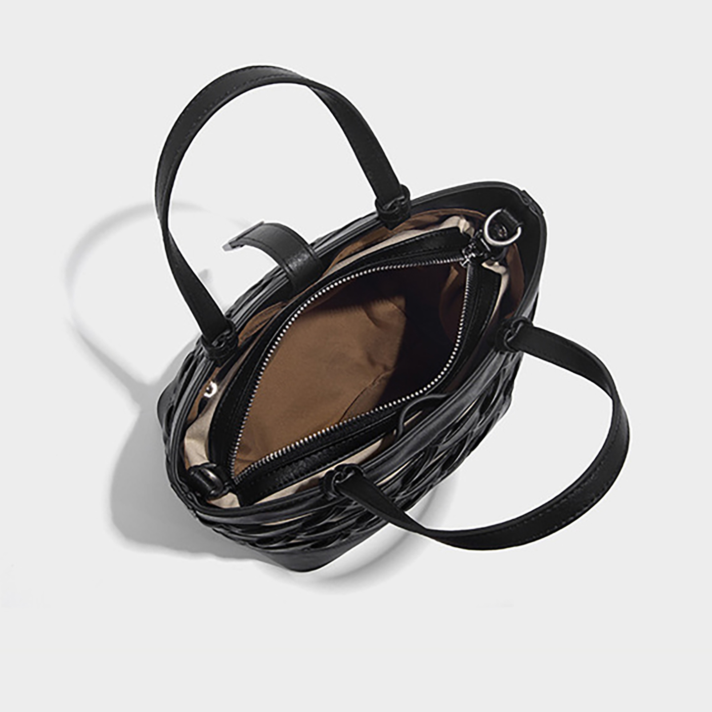 Interior view showing zip-top opening and phone pocket of the medium bucket bag.