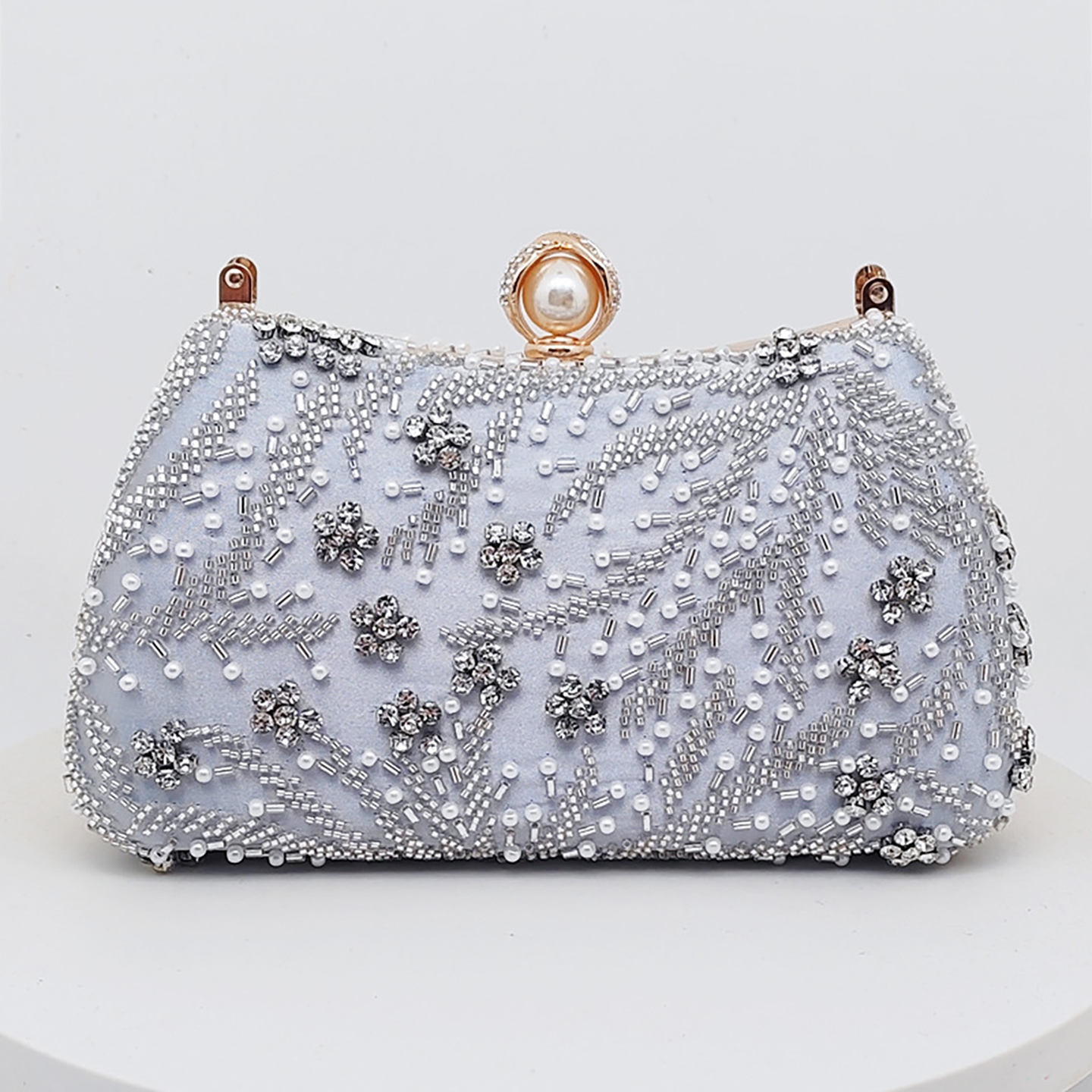 Silver beaded silk evening handbag with floral rhinestone embroidery.