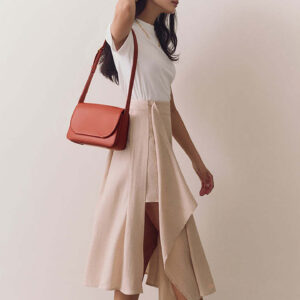 Model wearing terracotta flap bag over shoulder with casual outfit for daily wear