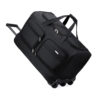 Angled view of black large capacity expandable travel bag with wheels, trolley handle, and multiple zipper pockets