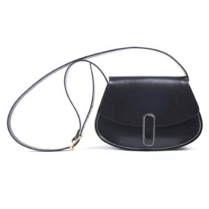 Front view of black women's saddle bag with contrast stitching, magnetic buckle, and adjustable strap