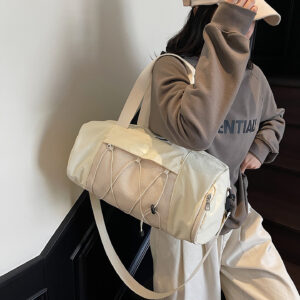 Lifestyle image of person carrying cream multifunctional travel duffel bag in casual setting