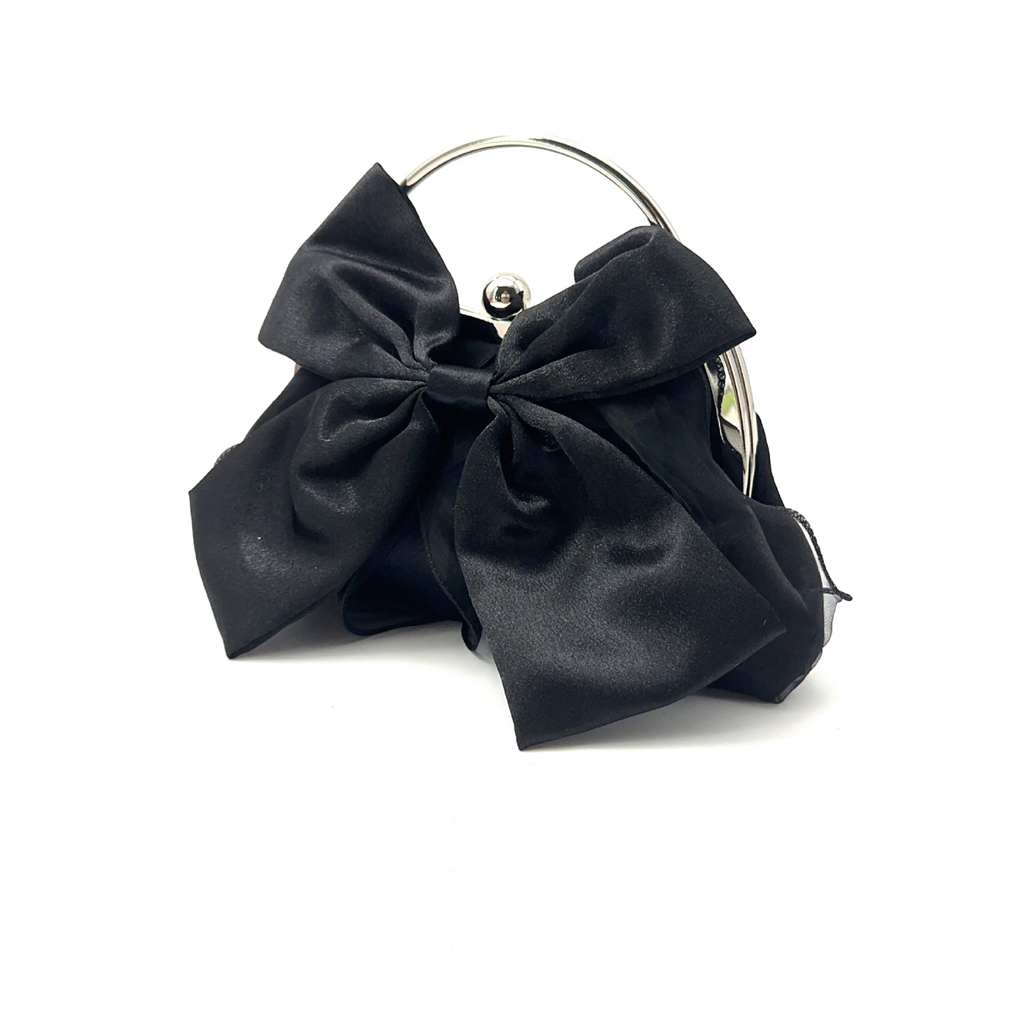 Side profile of black bow shaped handbag highlighting ruffle details and metal ball clasp