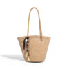 Beige woven straw bucket bag with tassel pendant featuring beads and leaf accents for bohemian casual wear