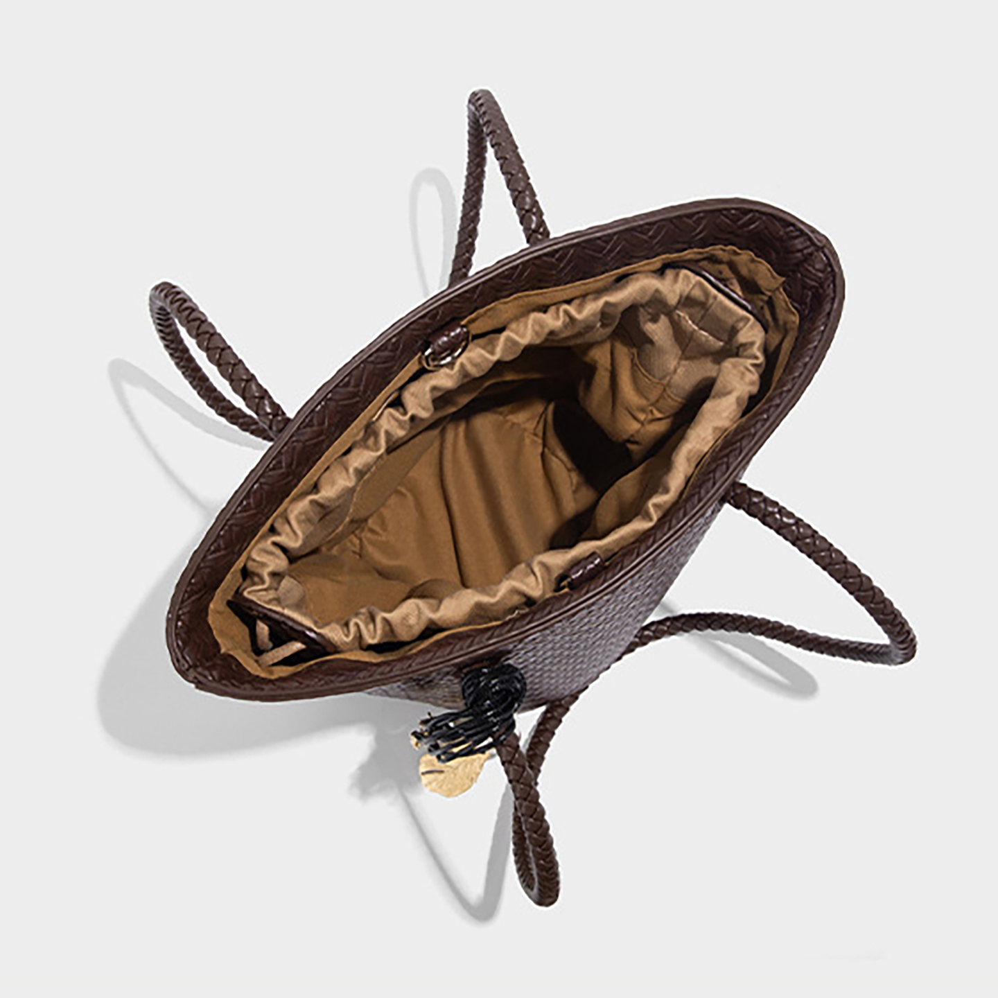 Open view of brown bohemian bucket bag showing polyester lining and inner drawstring pouch