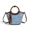 Front view of minimalist denim-inspired woven PU handbag with zipper closure and shoulder strap