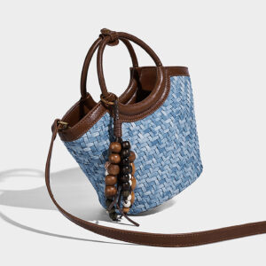 Close-up detail of bead charm and PU material on woven summer purse