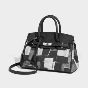 Front view of black and white contrast denim Birkin handbag with shoulder strap