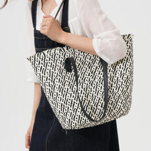 Model wearing beige large beach bag